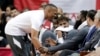 Houston Rockets guard Russell Westbrook, left, grabs at James Harden as they joke around at the bench during the second half of an NBA basketball preseason game against the Shanghai Sharks, Monday, Sept. 30, 2019, in Houston. 