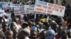 People originally from northern Mali carry signs reading 'We support army action to liberate the North,' as thousands of Malians, including elected officials, front, marched in support of foreign aid and military intervention to retake Mali's north from I