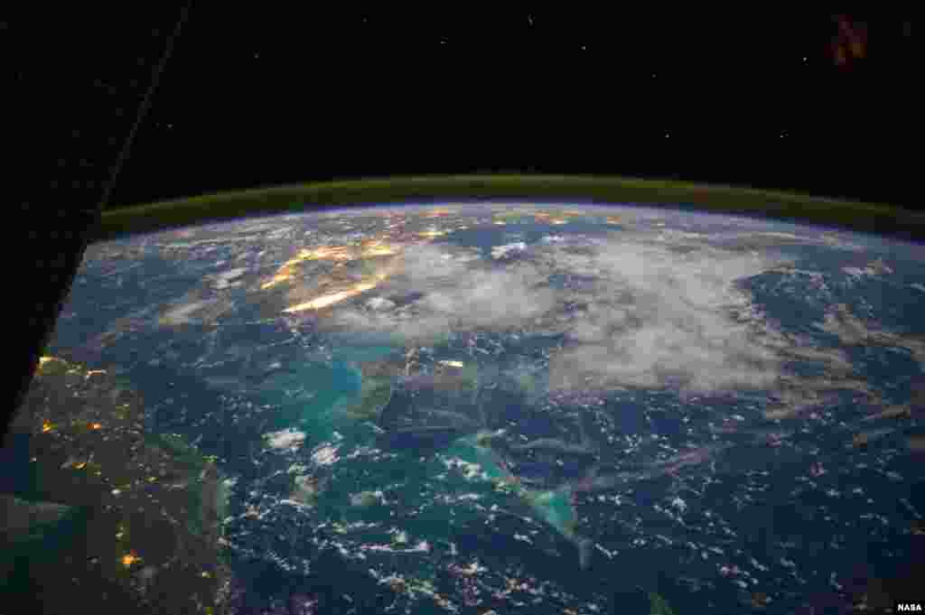 From the Earth-orbiting International Space Station, flying some 225 nautical miles above the Caribbean Sea, NASA astronaut Reid Wiseman photographed this north-looking panorama that includes parts of Cuba, the Bahama and Florida, and even runs into several other areas in the southeastern U.S. The long stretch of lights to the left of center frame gives the shape of Miami.