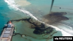 FILE - A general view shows the bulk carrier ship MV Wakashio that ran aground on a reef, at Riviere des Creoles, Mauritius, in this handout image obtained by Reuters Aug. 11, 2020. (French Army command/handout via Reuters)