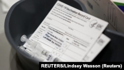USA, Seatle, Washington, A Pfizer coronavirus disease (COVID-19) vaccine card is seen at a mass vaccination site