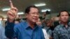 Cambodian Prime Minister Hun Sen of the Cambodian People's Party shows off his inked finger after voting in local elections at Takhmau polling station in Kandal province, southeast of Phnom Penh, Cambodia, Sunday, June 4, 2017. (AP Photo/Heng Sinith)
