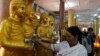 ពលរដ្ឋ​ម្នាក់​នេះ ថ្វាយ​ថវិកា​ដល់​ព្រះពុទ្ធរូប​ គ្រាដែល​អ្នកស្រី​បួងសួង​ក្នុង​ពេល​បុណ្យ​ចូលឆ្នាំខ្មែរ​នៅ​ថ្ងៃច័ន្ទ​ទី១៤ ខែមេសា ឆ្នាំ ២០១៤ នៅ​ក្នុង​ទីក្រុង​ភ្នំពេញ នៃ​ប្រទេស​កម្ពុជា។