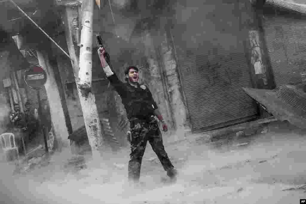 A rebel fighter is seen after he fired a shoulder-fired missile toward a building where Syrian troops loyal to President Bashar al-Assad were, Aleppo, Syria, November 4, 2012.