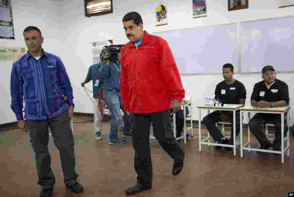 Venezuela's President Nicolas Maduro arrives at a polling station to vote.