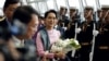 Myanmar Migrants in Thailand Rush Police, Greet Suu Kyi  