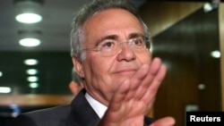 FILE - Brazil's Senate President Renan Calheiros waves to photographers in Brasilia, Brazil, Dec. 7, 2016. 
