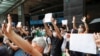 Supporters raise white paper to avoid slogans banned under the national security law as they support arrested anti-law protester outside Eastern court in Hong Kong, China, July 3, 2020. 