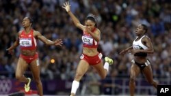 United States' Allyson Felix crosses the finish line to win the women's 200-meters final ahead of compatriot Carmelita Jeter, left, and Ivory Coast's Murielle Ahoure, at the 2012 Summer Olympics in London.