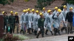 Rescuers walk toward the entrance to a cave complex in Mae Sai, Chiang Rai province, northern Thailand Tuesday, July 10, 2018. Eight boys have been rescued from the flooded cave. (AP Photo/Sakchai Lalit)