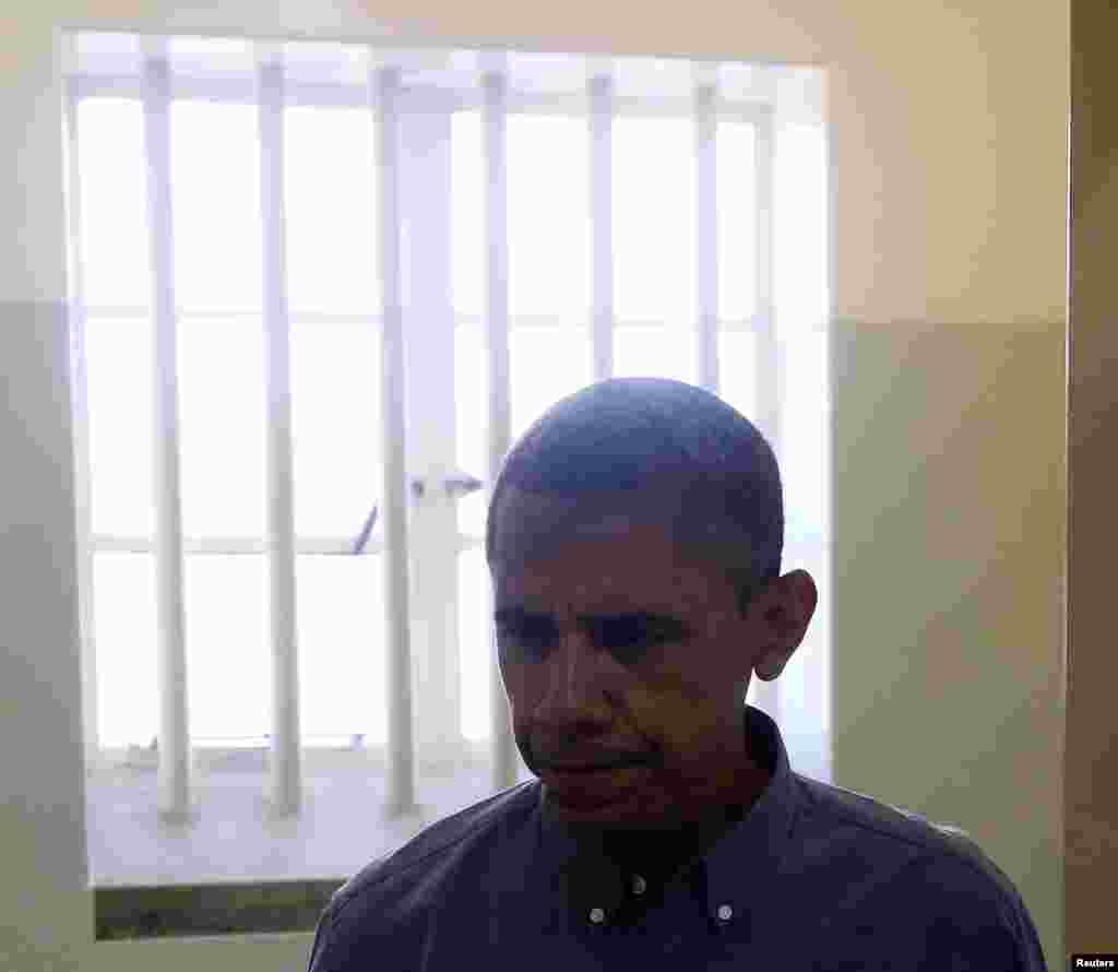U.S. President Barack Obama departs the Robben Island prison cell where Nelson Mandela spent 18 of his 27 years of imprisonment near Cape Town, June 30, 2013.