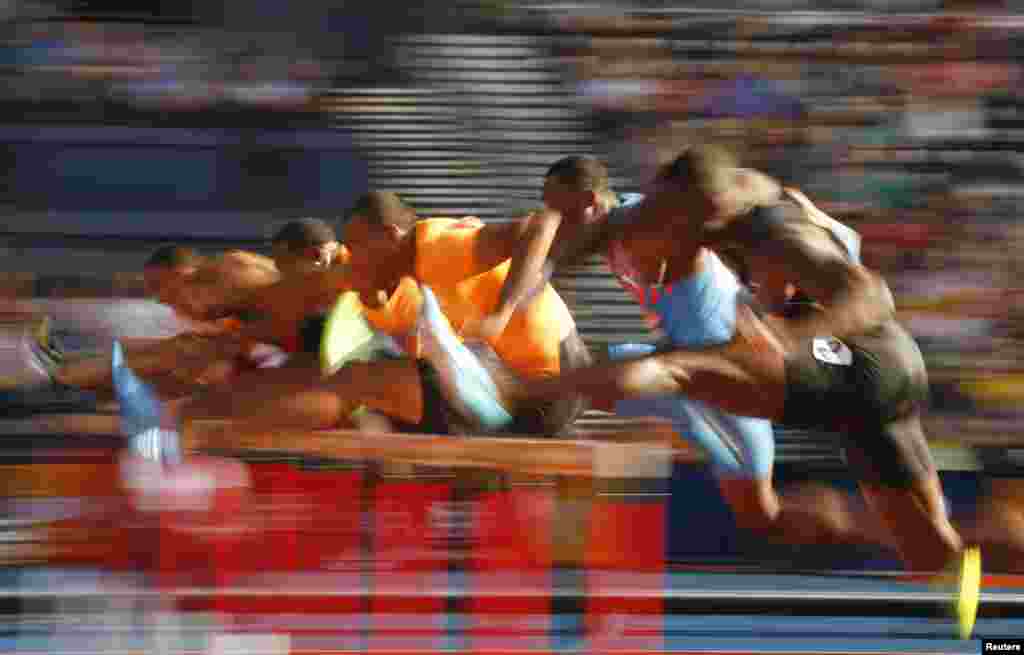 Competitors clear hurdles during a heat of the men's 110m hurdles during the IAAF Diamond League athletics meeting at Hampden Park in Glasgow, Scotland.
