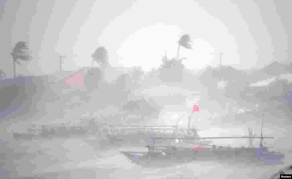 Fishing boats amid heavy winds and rain brought by Typhoon Rammasun (locally named Glenda) as it hit the town of Imus, Cavite southwest of Manila, July 16, 2014.