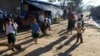 Myanmar ethnic Kachin refugees gather as school children go to school, at their residence at Wine Maw Refugee Camp in Kachin State (AP Photo/Khi