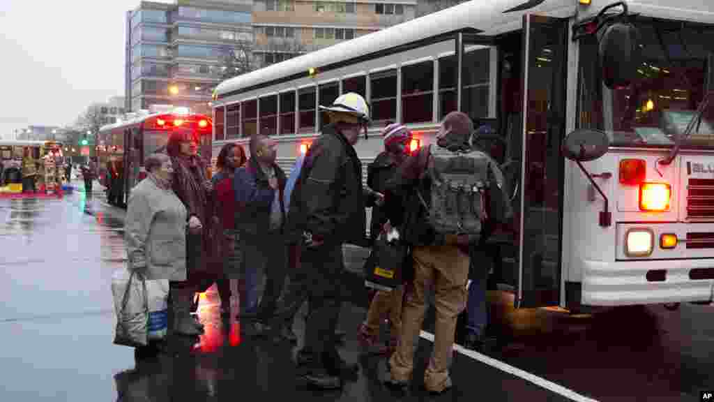 Toussant, les personnes évacuées d'un tunnel de métro de métro enfumé sont embarquées dans un bus à Washington, lundi 12 janvier, 2015.