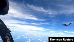 A plane with a Chinese flag on its tail is seen in this handout picture, June 2, 2021.