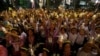 Well-wishers hold lit candles and portraits of Thailand's King Bhumibol Adulyadej at Siriraj hospital, where a group has gathered to mark his 88th birthday, in Bangkok, Thailand, Dec. 5, 2015. 