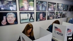  Voters fill out their ballots at the Los Angeles County Registrar, Oct. 23, 2018, in Norwalk, Calif. 