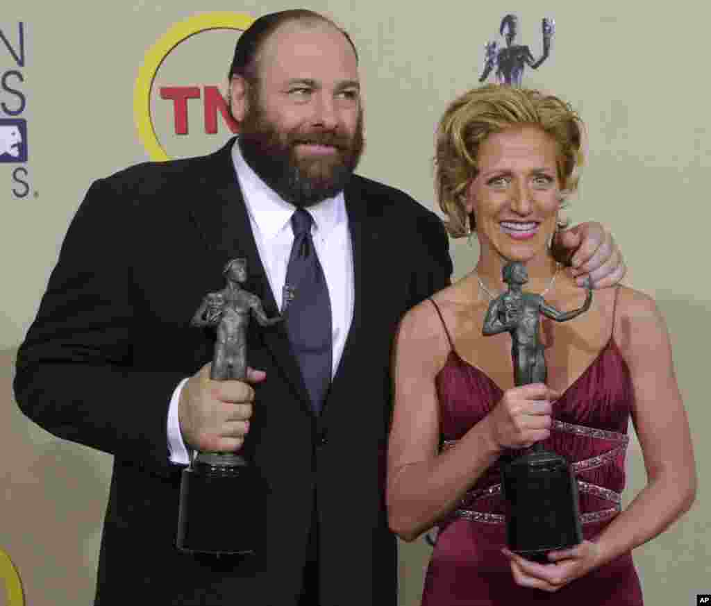 James Gandolfini and Edie Falco display awards they received for their respective outstanding performances by lead actors in the drama series "The Sopranos" at the 9th annual Screen Actors Guild awards in Los Angeles, California, March 9, 2003.