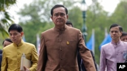 FILE - Thai Prime Minister Prayuth Chan-ocha, center, arrives at the government house in Bangkok, Thailand.
