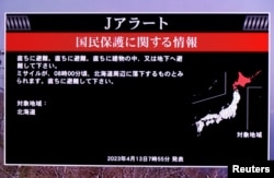 A TV screen displays a warning message called "J-alert" after the Japanese government issued an alert, following a ballistic missile launch by North Korea
