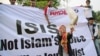 FILE - A woman releases a dove as a symbol of peace during a rally against the Islamic State group in Jakarta, Indonesia, Sept. 5, 2014. 