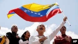 Pemimpin oposisi Venezuela Maria Corina Machado melambaikan bendera Venezuela dalam demonstrasi memprotes hasil pilpres yang memenangkan petahana Presiden Nicolas Maduro, di Caracas, Venezuela, 17 Agustus 2024. (Foto: Cristian Hernandez/AP Photo)