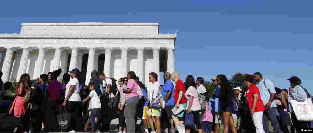 Marchers file towards their seats at the ceremony at the Lincoln Memorial honoring the 50th anniversary of the 1963 March on Washington, Aug. 24, 2013.