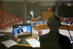 Afghanistan's U.N. ambassador Ghulam Isaczai is seen on a monitor in a translators booth as the United Nations Security Council meets regarding the situation in Afghanistan at the United Nations in New York City, New York, Aug. 16, 2021.