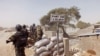 FILE- Cameroon soldiers stand guard at a lookout post as they take part in operations against the Islamic extremists group Boko Haram near the village of Fotokol, Feb. 25, 2015. 