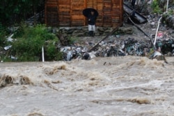 A man watches the rising water of the Rio Bermejo in the wake of Hurricane Iota in San Pedro Sula, Honduras, Nov. 17, 2020.
