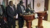 South Sudan President Salva Kiir (C), flanked by former rebel leader Riek Machar (L) and other government officials, addresses a news conference at the Presidential State House in Juba, South Sudan, July 8, 2016. 