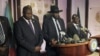 South Sudan President Salva Kiir (C), flanked by former rebel leader Riek Machar (L) and other government officials, addresses a news conference at the Presidential State House in Juba, South Sudan, July 8, 2016. 