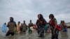 In this July 26, 2019 photo, Ethiopian migrants disembark from a boat onto the shores of Ras al-Ara, Lahj, Yemen. Funded by the European Union, Ethiopia has cracked down on migrant smugglers and intensified border controls. Arrests of known brokers…