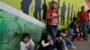 Sandra Ramirez stands with four of her children along the walkway to the United States to support members of the group Border Dreamers, Tijuana, Mexico, March 10, 2014.