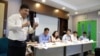 Suon Bunsak, executive secretary of the Cambodian Human Rights Action Committee (CHRAC) holds the pocket version of Cambodia's constitutional law during a press conference on the “stop and consult” campaing about the draft Law on Associations and Nongovernmental Organizations on Monday, May 4, 2015. Representatives of some 270 NGOs and INGOs sat in a panel during the press conference on the contoversial proposed law they say is aimed at restricting their work. (Noeu Vannarin/VOA Khmer)