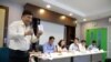 Suon Bunsak, executive secretary of the Cambodian Human Rights Action Committee (CHRAC) holds the pocket version of Cambodia's constitutional law during a press conference on the “stop and consult” campaing about the draft Law on Associations and Nongovernmental Organizations on Monday, May 4, 2015. Representatives of some 270 NGOs and INGOs sat in a panel during the press conference on the contoversial proposed law they say is aimed at restricting their work. (Neou Vannarin/VOA Khmer)