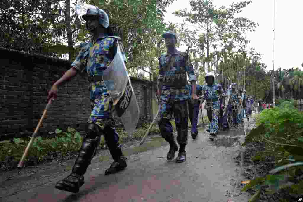 Bangladeshi police patrol after Buddhist temples were torched in an overnight attack in Ramu in the coastal district of Cox's Bazar, Bangladesh, October 1, 2012.
