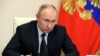 FILE - Russian President Vladimir Putin chairs a joint meeting of the country's State Council and the Council for Strategic Development and National Projects, Dec. 23, 2020.