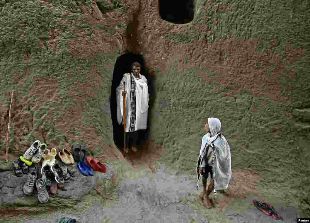 Seorang penganut Kristen Ortodok berdiri di antara gereja yang dibuat dari batu saat peringatan Jumat Agung di Lalibela, Ethiopia.