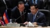 Cambodia's Prime Minister Hun Sen, talks to Cambodia's Foreign Minister Hor Namhong before the plenary session meeting for 26th ASEAN Summit in Kuala Lumpur, Malaysia, on Monday, April 27, 2015. (AP Photo/Joshua Paul)
