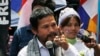 An activist of Cambodian National Rescue Party Meach Sovannara, left, gives a speech at a blocked main street near the Phnom Penh Municipality Court, file photo. 