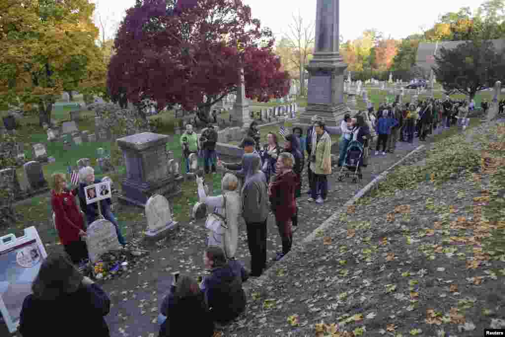 People line up to visit the grave of women's suffrage leader Susan B. Anthony on U.S. election day at Mount Hope Cemetery in Rochester, New York.