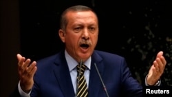 Turkey's Prime Minister Recep Tayyip Erdogan addresses members of his ruling AK Party, at its headquarters in Ankara, Dec. 25, 2013.