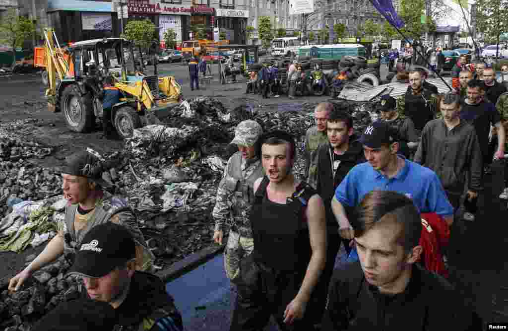 Members of Maidan self-defense forces march along the street in central Kyiv, April 23, 2014.