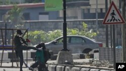 Police officers detain a protester at the Lekki toll gate in Lagos, Nigeria, Oct. 21, 2020.