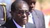 FILE - Zimbabwean President, Robert Mugabe, attends the burial of Major General Bandama who died after a short illness at the National Heroes acre in Harare, July, 17, 2014.