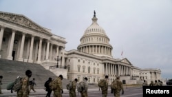 Members of the National Guard arrive to the U.S. Capitol days after supporters of U.S. President Donald Trump stormed the Capitol in Washington, D.C.