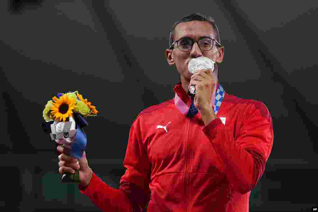 Ahmed Elgendy of Egypt celebrates on the podium during the medal ceremony for the men's modern pentathlon at the 2020 Summer Olympics, Saturday, Aug. 7, 2021, in Tokyo, Japan. (AP Photo/Hassan Ammar)