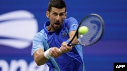 (FILES) Serbia's Novak Djokovic returns the ball to Russia's Daniil Medvedev during the US Open tennis tournament men's singles final match at the USTA Billie Jean King National Tennis Center in New York on September 10, 2023. (Photo by kena betancur / AF